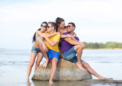 summer, holidays, vacation, happy people concept - group of friends having fun on the beach