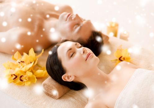 health and beauty concept - couple in spa salon lying on the massage desks