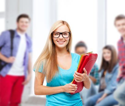 school and education concept - smiling student with folders