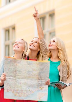 holidays and tourism concept - beautiful blonde women with tourist map in the city