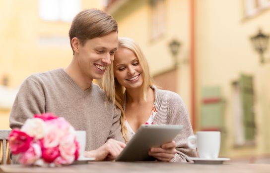 summer holidays, city, dating and technology concept - couple with tablet pc in cafe