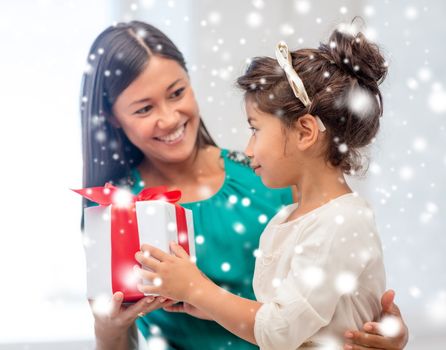 holidays, presents, christmas, x-mas, birthday concept - happy mother and child girl with gift box