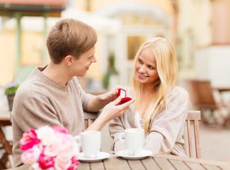 summer holidays, love, travel, tourism, relationship and dating concept - romantic man proposing to beautiful woman