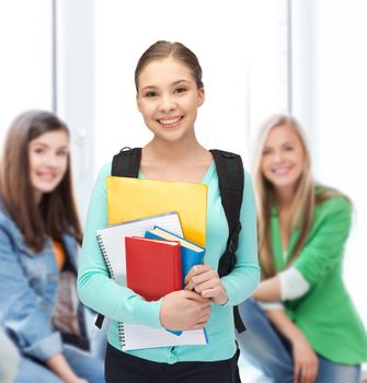 education, youth, school, teamwork concept - smiling student with books and schoolbag