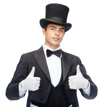 magic, performance, circus, show concept - magician in top hat showing thumbs up