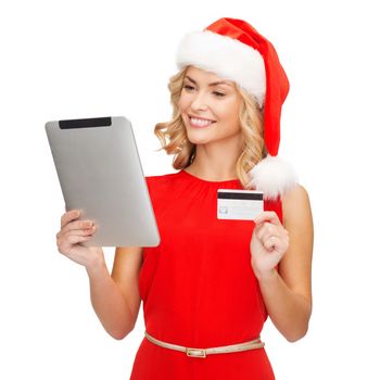 christmas, x-mas, online shopping concept - woman in santa helper hat with tablet pc computer and credit card