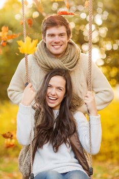 holidays, love, travel, tourism, relationship and dating concept - romantic couple in the autumn park