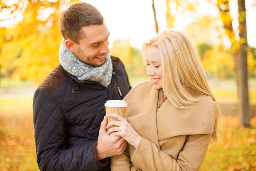 holidays, love, travel, tourism, relationship and dating concept - romantic couple in the autumn park