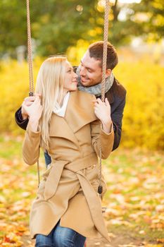 holidays, love, travel, tourism, relationship and dating concept - romantic couple in the autumn park