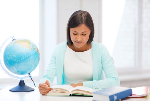 education and school, travel concept - female teacher with globe and book