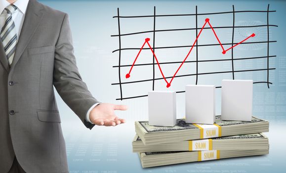 Businessman points hand on white boxes and money. Schedule of price increases in background