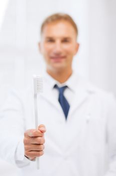 healthcare, medical and stomatology - dentist with toothbrush in hospital