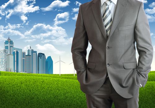 Businessman standing with hands in pockets. Urban scene as backdrop