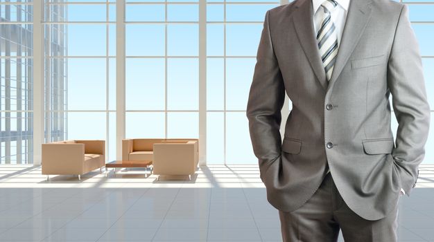 Businessman wearing a suit. Large window in office building as background