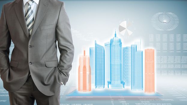 Businessman standing with hands in pockets. On background of the high-tech wire frame skyscrapers and graphs