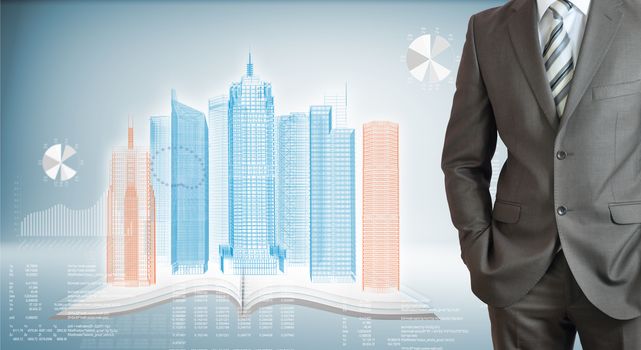 Businessman standing with hands in pockets. On background of the high-tech wire frame skyscrapers, book and graphs