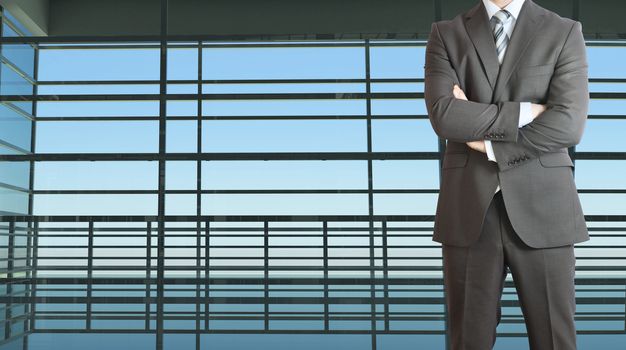 Businessman wearing a suit. Large window in the airport terminal as background