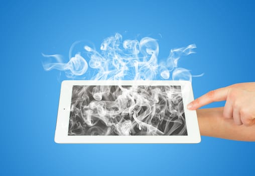 Hands holding tablet pc with white smoke. The technology concept