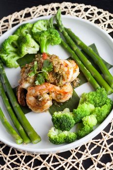 Shrimp scampi seafood dish with broccoli and asparagus.