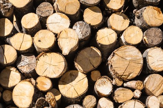 Image about a pile of firewood with some shadow