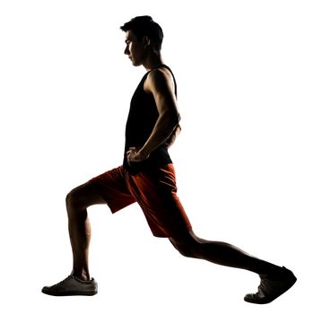 Asian man exercising fitness workout lunges crouching in silhouette on white background.