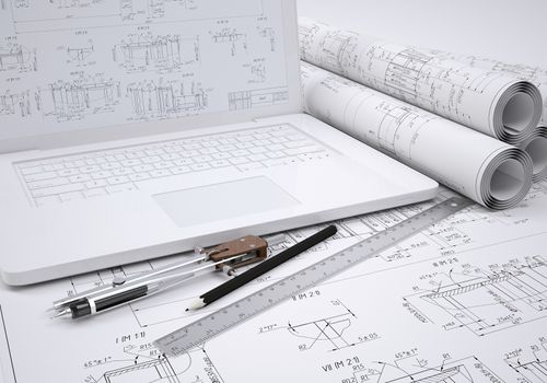Scrolls engineering drawings and laptop. Desk Engineer