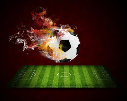 Soccer ball in the color of flame and smoke. Sport concept