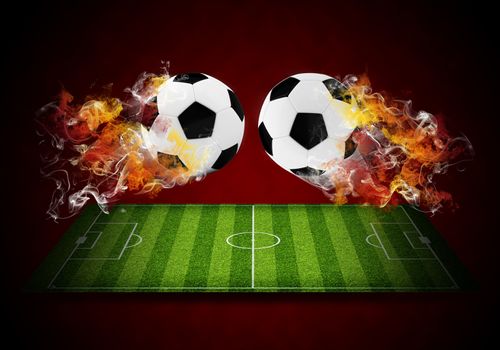 Two soccer balls in the color of flame and smoke. Sport concept