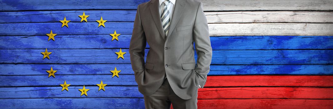 Businessman in a suit. European Union and Russian flags as background. Concept of business