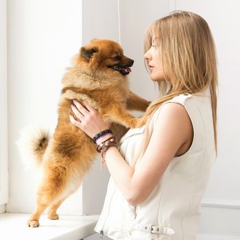 Cute, attractive girl with fluffy dog