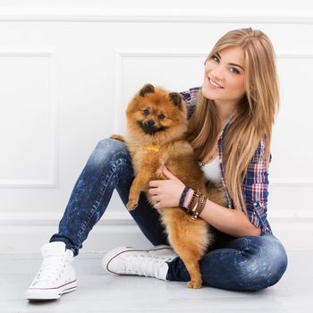 Cute, attractive girl with fluffy dog