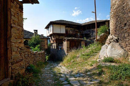 Street with old houses in Kovatchevitsa village, Bulgaria