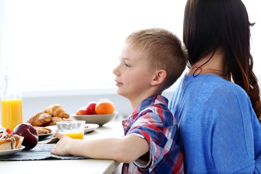 Mother with kid during family breakfast