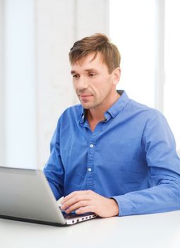 technology, business and lifestyle concept - man working with laptop at home