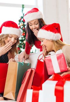 shopping, sale, gifts, christmas, x-mas concept - smiling women in santa helper hats with shopping bags and many gift boxes