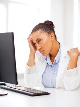 business, office, school and education concept - stressed african businesswoman with computer at work