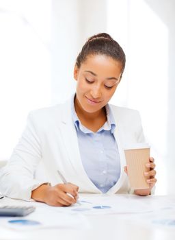 business, office, school and education concept - businesswoman with documents and takeaway coffee