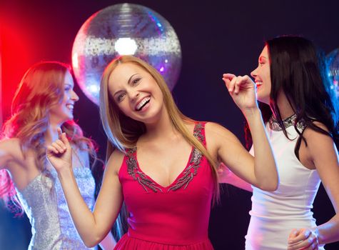 party, "new year", celebration, friends, bachelorette party, birthday concept - three beautiful women in evening dresses dancing in the club