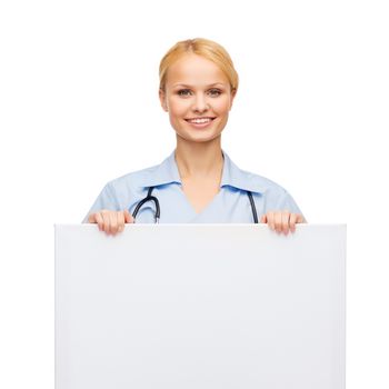 healthcare, medicine, advertisement and sale concept - smiling female doctor or nurse with stethoscope and white blank board