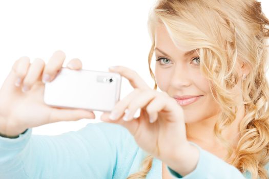 technology concept - smiling woman taking photo with smartphone