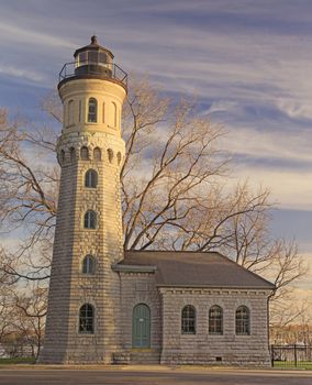 Old time brick lighthouse at historic Fort Niagara stands tall against beautiful cirrus clouds. 