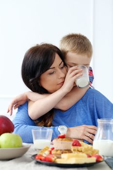 Mother with kid during family breakfast