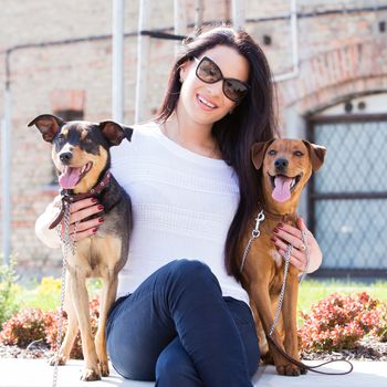 Outdoor. Cute, attractive girl with beautiful dogs