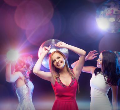party, celebration, friends, bachelorette party, birthday concept - three beautiful women in evening dresses dancing in the club