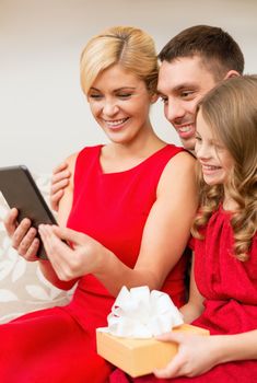 family, christmas, x-mas, winter, happiness, technology and people concept - smiling family with tablet pc