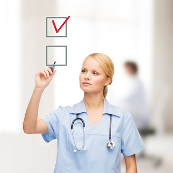 healthcare, medical and technology - young doctor or nurse with marker drawning red checkmark into checkbox