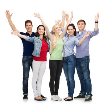 education and people concept - group of smiling students standing and waving hands