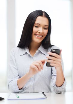 education, school, business, communication and technology concept - smiling businesswoman or student with smartphone texting