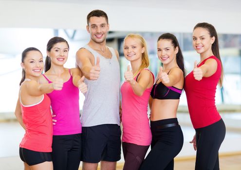 fitness, sport, training, gym and lifestyle concept - group of happy people in the gym showing thumbs up