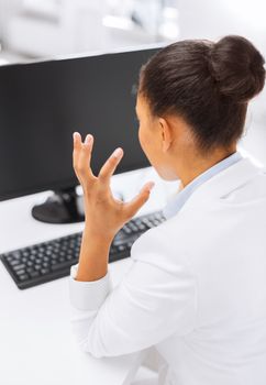 business, office, school and education concept - stressed businesswoman with computer at work